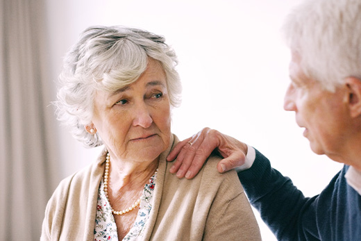 Hospice care tailored to each patient Sad looking older woman looking at her husband.