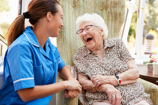 Personalized memory care focused on support and compassion 2 women laughing.